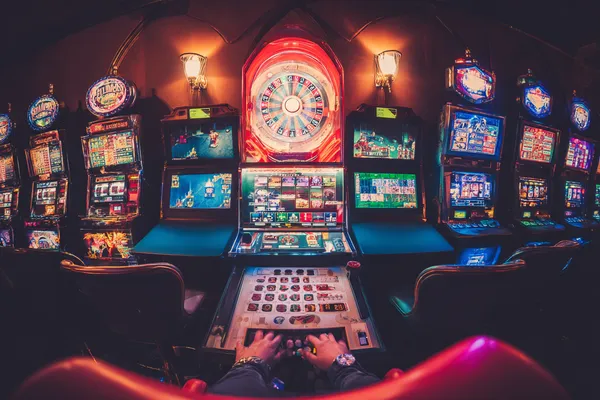 A close-up shot of golden coins falling around a spinning roulette wheel, representing immersive casino action at TKPK.