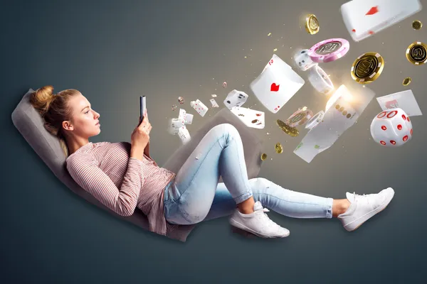 A player using their smartphone during a festive local event, representing TKPK’s fully mobile-friendly casino.